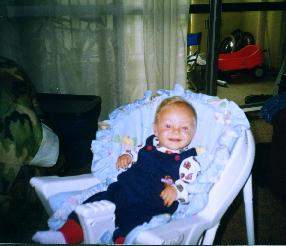 smiling in his chair